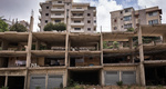 Urban refugees often struggle to afford decent shelter and many in Lebanon claim unfinished or abandoned buildings as their home. While the Syrian families living in this unfinished building do not pay rent, they also lack running water (Photo: copyright Jacob Russell, International Rescue Committee)